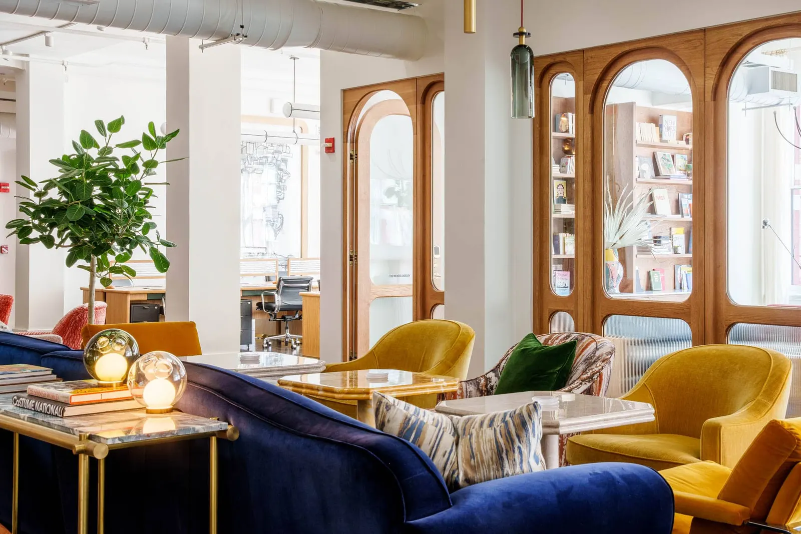 The Malin SoHo — lounge with custom blue velvet sofas and gold armchairs